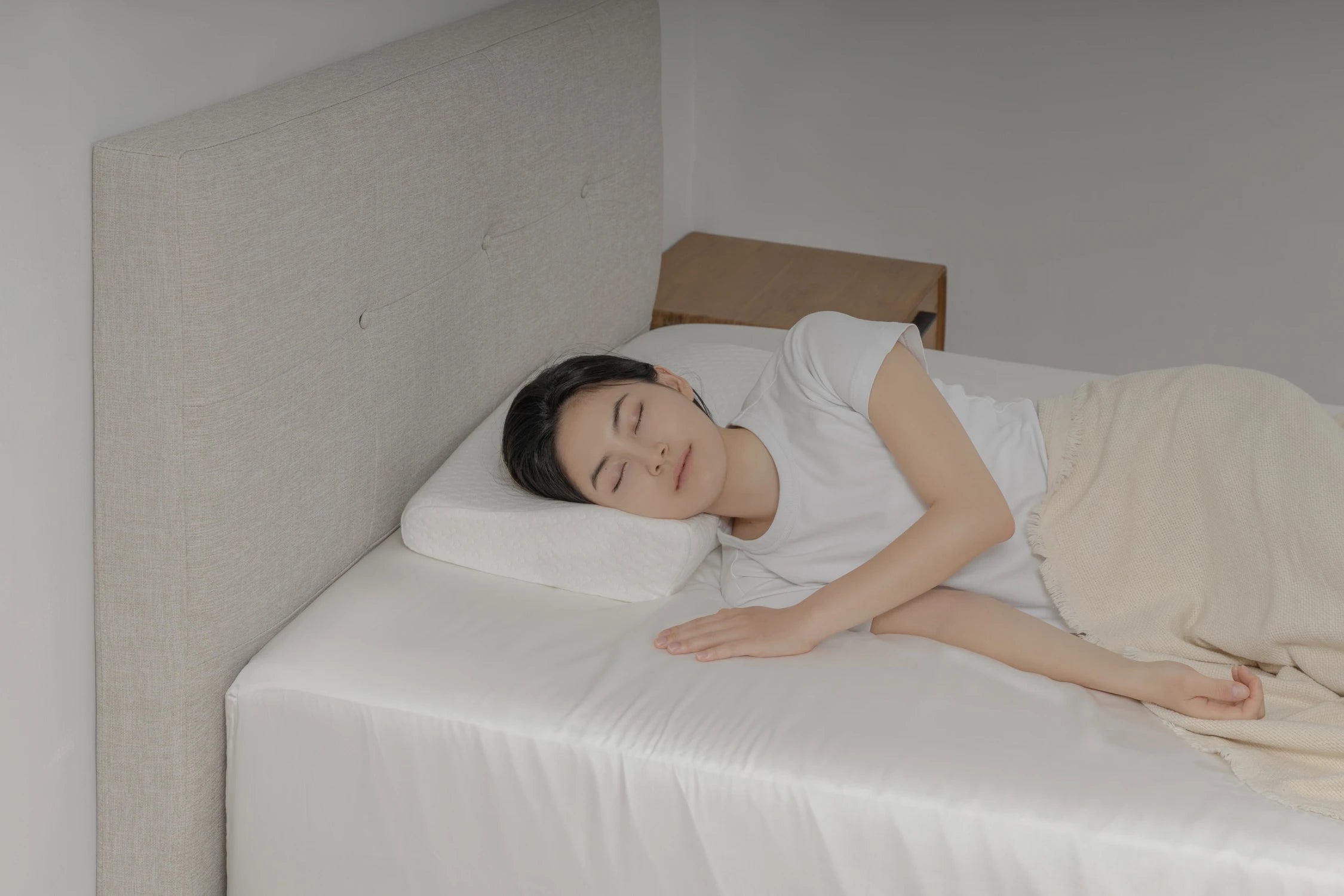 護頸工學記憶枕產品情境照 - 女子側躺於床上使用護頸工學記憶枕